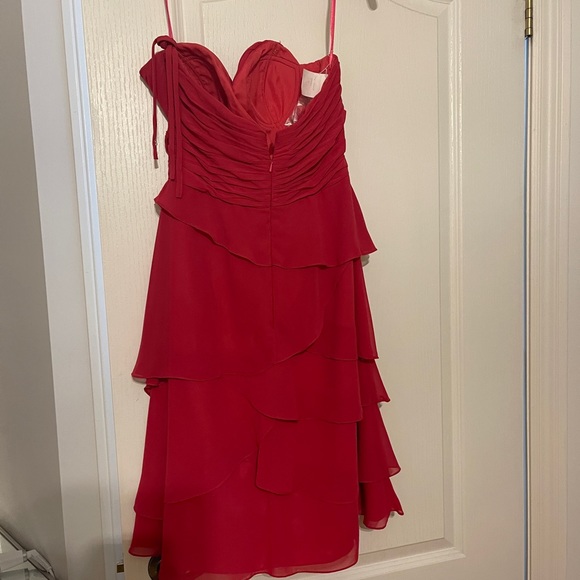 Dress never worn. 

Color: bright pink. 

Comes with removable straps. - Picture 4 of 6
